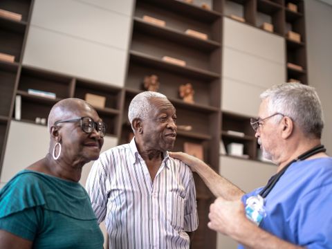 African American Man and Woman talking with Doctor. 