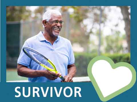 African American man smiling and holding tennis racket.